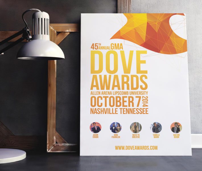 A poster for the dove awards featuring a captivating web design, strategically placed on a table adorned with a stylish lamp.
