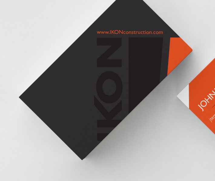 A black and orange brand card on a white surface.