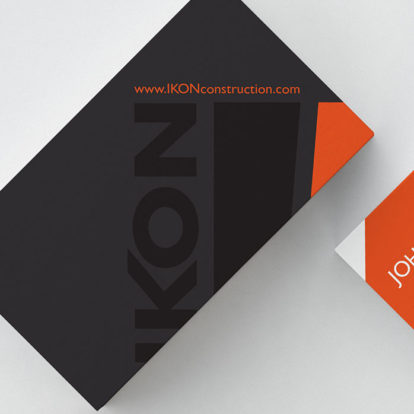 A black and orange business card with the word ikon on it, representing a branding company specializing in web design.